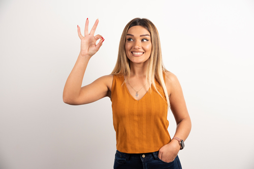 Young woman model showing ok gesture and posing. High quality photo