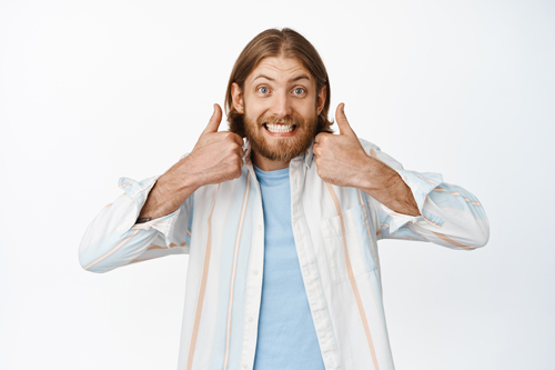 Sounds good. Funny blond guy smiling, showing thumbs up in approval, like great choice, support you, praise great idea, standing satisfied against white background.