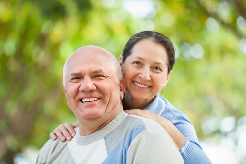 Portrait of mature couple in sweaters at autumn park